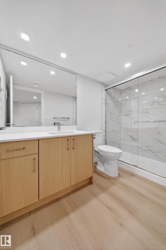 Bathroom featuring a light wood-finish vanity with a white countertop and rectangular sink - 20723 24 Avenue, Edmonton, AB - Indoor Photo Showing Bathroom