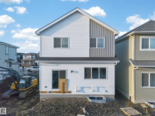 Contemporary rear elevation featuring white horizontal siding and gray vertical siding accents - 20723 24 Avenue, Edmonton, AB - Outdoor
