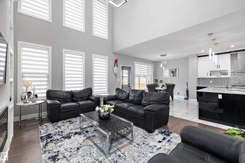 Soaring ceilings and abundant natural light highlight this open concept living area - 714 Ebbers Place, Edmonton, AB - Indoor Photo Showing Living Room