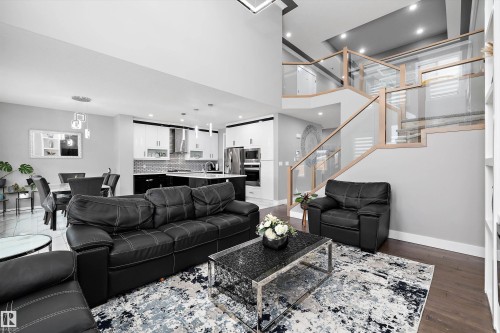 Spacious living area featuring high ceilings and dark wood-finish flooring - 714 Ebbers Place, Edmonton, AB - Indoor Photo Showing Living Room