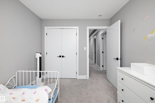 Room featuring light gray walls, textured carpet flooring, and white trim - 714 Ebbers Place, Edmonton, AB - Indoor