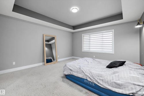 Recessed tray ceiling with contrasting accent, light gray walls, and plush carpeting - 714 Ebbers Place, Edmonton, AB - Indoor Photo Showing Bedroom