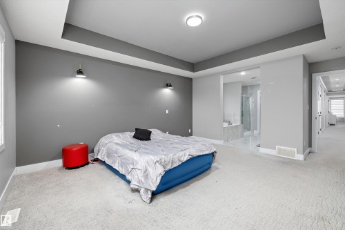 Room featuring tray ceiling, recessed lighting, and wall-mounted sconces - 714 Ebbers Place, Edmonton, AB - Indoor Photo Showing Bedroom