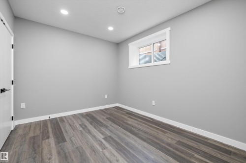 Room featuring light gray walls, recessed ceiling lighting, and wood-finish flooring - 714 Ebbers Place, Edmonton, AB - Indoor Photo Showing Other Room