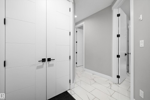 Entryway featuring white tile flooring with gray veining - 714 Ebbers Place, Edmonton, AB - Indoor Photo Showing Other Room