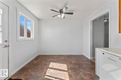 Bright interior space featuring a window, tile flooring, and a ceiling fan - 