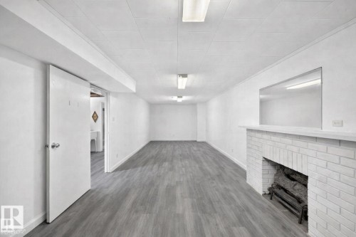 7719 71 Avenue, Edmonton, AB - Indoor Photo Showing Other Room With Fireplace