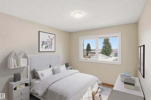 Bedroom featuring light beige walls and a single window with white trim - 23 Clearwater, Devon, AB - Indoor Photo Showing Bedroom