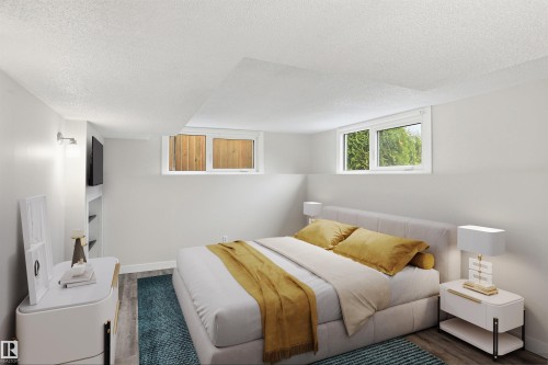 Room featuring two egress windows, built-in shelving, wood-finish flooring, and light-colored walls - 23 Clearwater, Devon, AB - Indoor Photo Showing Bedroom