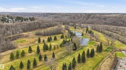 Expansive golf course setting featuring multiple greens and fairways - 