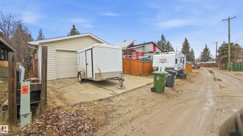 Detached garage with horizontal siding, a single garage door, and a concrete driveway - 23 Clearwater, Devon, AB - Outdoor
