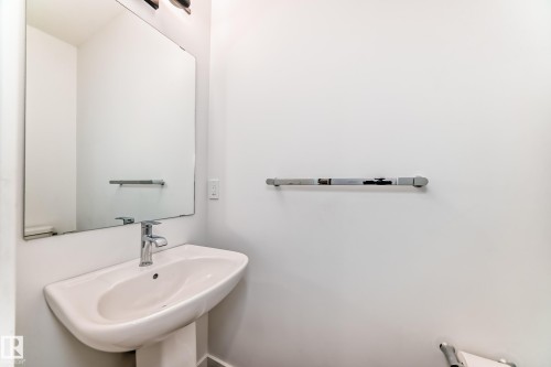Pedestal sink with chrome faucet - 38 1910 Collip View, Edmonton, AB - Indoor Photo Showing Bathroom