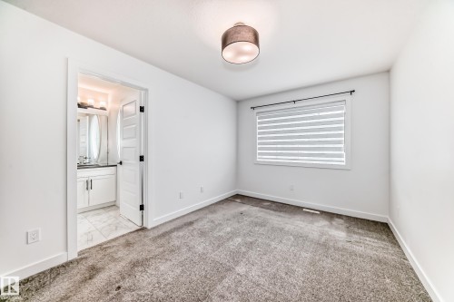 Bedroom featuring gray carpet, a contemporary drum light fixture, and a window with horizontal blinds - 38 1910 Collip View, Edmonton, AB - Indoor Photo Showing Other Room