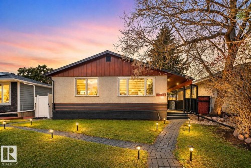 Front exterior with a stucco finish and wood-paneled gable - 13332 106 Street, Edmonton, AB - Outdoor