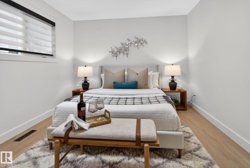 Bright bedroom featuring light wood-finish flooring and a window with blinds - 13332 106 Street, Edmonton, AB - Indoor Photo Showing Bedroom
