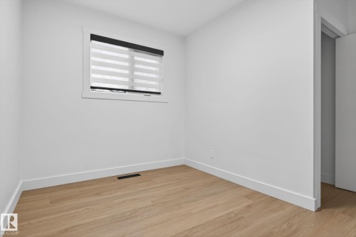 Neutral white walls with crisp baseboards - 13332 106 Street, Edmonton, AB - Indoor Photo Showing Other Room