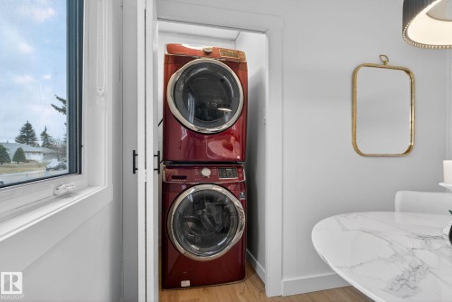 Dedicated laundry closet featuring a stacked washer and dryer unit - 13332 106 Street, Edmonton, AB - Indoor Photo Showing Laundry Room