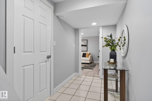 Hallway featuring light-toned tile flooring and white trim - 13332 106 Street, Edmonton, AB - Indoor Photo Showing Other Room