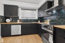 Contemporary kitchen featuring dark cabinetry, wood-finish countertops, and a textured green subway tile backsplash - 13332 106 Street, Edmonton, AB  - Indoor Photo Showing Kitchen 