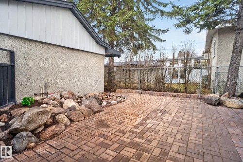 Brick paver patio featuring a decorative rock garden border - 13332 106 Street, Edmonton, AB - Outdoor