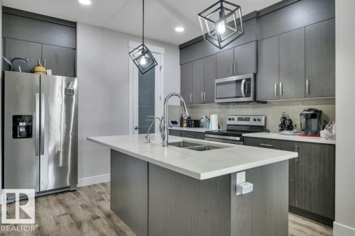 100 Aston Bend, Leduc, AB - Indoor Photo Showing Kitchen With Double Sink With Upgraded Kitchen