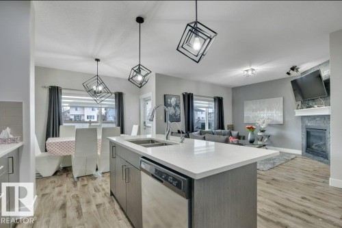 100 Aston Bend, Leduc, AB - Indoor Photo Showing Kitchen With Fireplace With Double Sink