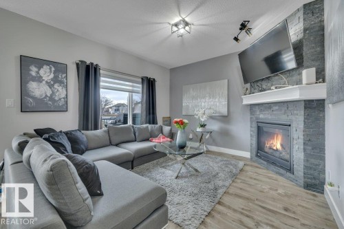 100 Aston Bend, Leduc, AB - Indoor Photo Showing Living Room With Fireplace