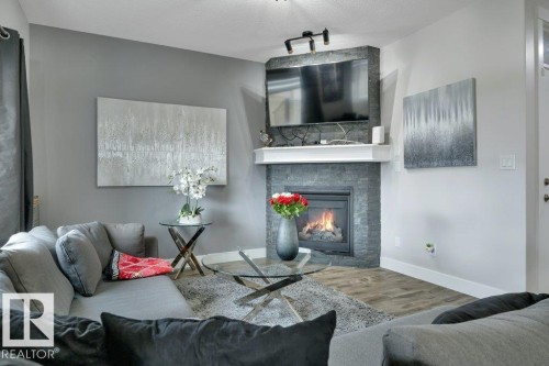 100 Aston Bend, Leduc, AB - Indoor Photo Showing Living Room With Fireplace