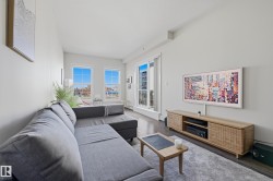 Living space featuring dark wood-finish flooring, light grey walls, and a recessed ceiling - 