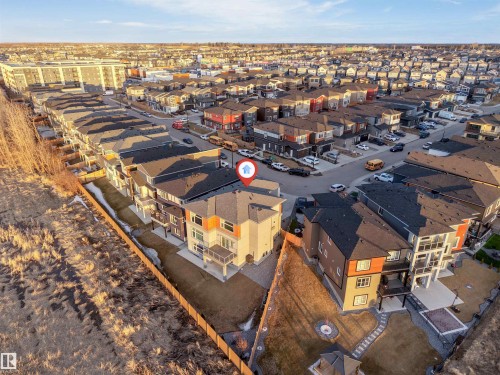 Aerial perspective showcasing a residential development with varied housing styles - 3736 1 Avenue Sw, Edmonton, AB - Outdoor With View