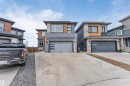 Modern architectural style featuring a multi-textured facade with stone, wood-finish paneling, and stucco - 3736 1 Avenue Sw, Edmonton, AB  - Outdoor With Facade 