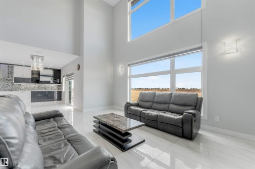 Double-height ceilings complement large windows - 3736 1 Avenue Sw, Edmonton, AB - Indoor Photo Showing Living Room