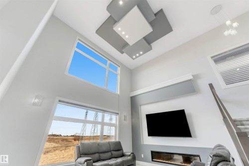 Vaulted ceiling featuring recessed lighting and a multi-tiered ceiling treatment - 3736 1 Avenue Sw, Edmonton, AB - Indoor With Fireplace