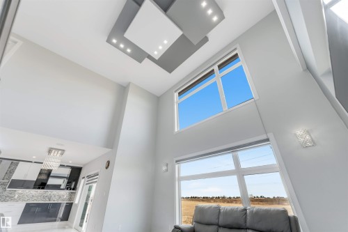 Double-height interior featuring a decorative ceiling treatment with recessed lighting - 3736 1 Avenue Sw, Edmonton, AB - Indoor Photo Showing Other Room