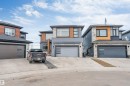 Contemporary two-story residence featuring a gray and wood-finish exterior, a two-car garage with frosted glass inserts, and concrete driveway - 3736 1 Avenue Sw, Edmonton, AB  - Outdoor With Facade 