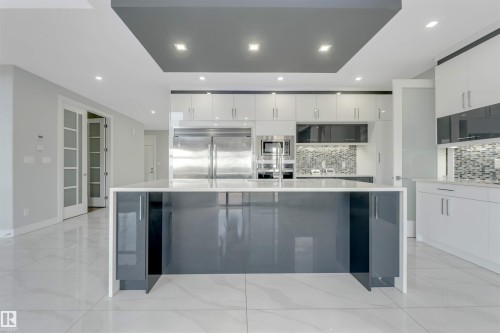 Contemporary kitchen island with a white countertop and high-gloss gray cabinetry - 3736 1 Avenue Sw, Edmonton, AB - Indoor Photo Showing Kitchen With Upgraded Kitchen