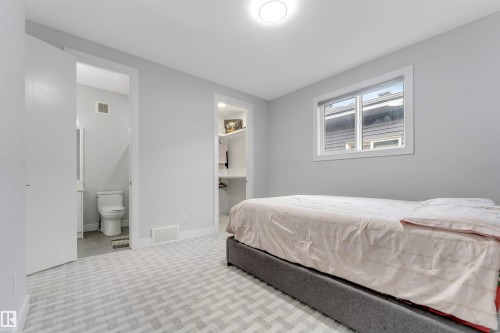 Bedroom featuring light gray walls and patterned carpet flooring - 3736 1 Avenue Sw, Edmonton, AB - Indoor Photo Showing Bedroom