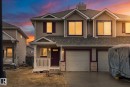 Multi-level residence featuring light-toned horizontal siding with dark trim accents - 5407 204 Street, Edmonton, AB  - Outdoor With Facade 