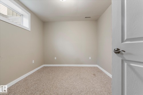 Neutral-toned walls and plush carpeting provide a versatile foundation - 5407 204 Street, Edmonton, AB - Indoor Photo Showing Other Room