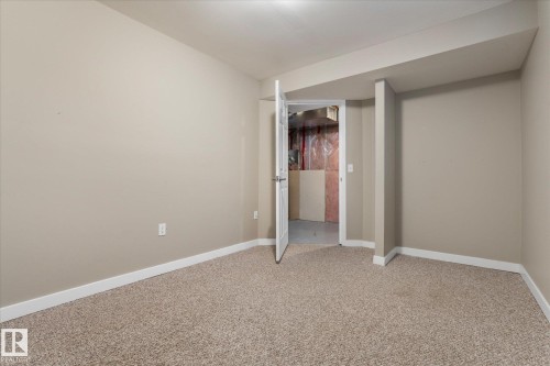 Neutral-toned walls complement the textured carpet flooring - 5407 204 Street, Edmonton, AB - Indoor Photo Showing Other Room