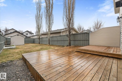 Expansive wooden deck with a multi-level design, gravel border, and durable privacy fencing - 5407 204 Street, Edmonton, AB - Outdoor With Deck Patio Veranda With Exterior