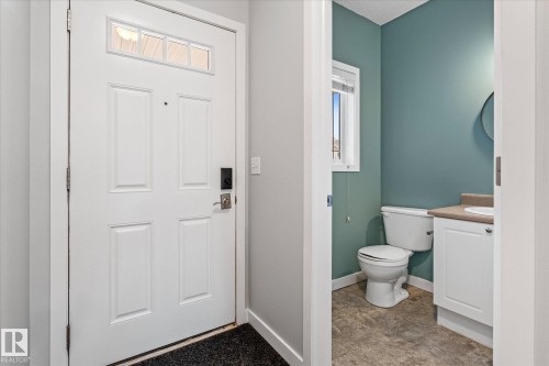 Front entry featuring a white paneled door with transom windows - 5407 204 Street, Edmonton, AB - Indoor Photo Showing Bathroom