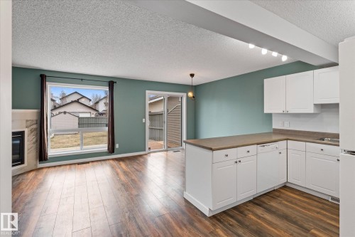 Kitchen featuring white cabinetry and light-colored countertops - 5407 204 Street, Edmonton, AB - Indoor Photo Showing Kitchen