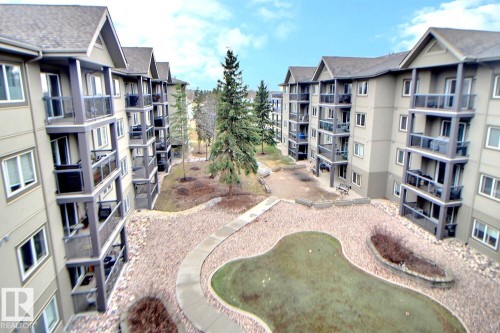 Multi-story residential buildings featuring individual balconies with glass railings - 413 279 Suder Greens Drive, Edmonton, AB - Outdoor
