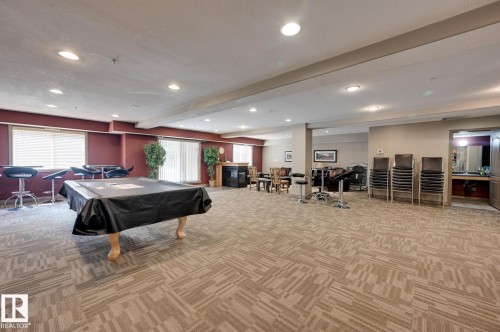 Spacious recreational room featuring patterned carpet flooring, recessed lighting, and ample natural light from multiple windows - 413 279 Suder Greens Drive, Edmonton, AB - Indoor Photo Showing Other Room