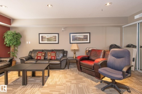Recessed ceiling lighting illuminates the patterned carpet flooring - 413 279 Suder Greens Drive, Edmonton, AB - Indoor Photo Showing Living Room
