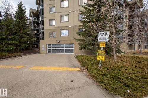 Multi-story building exterior featuring a neutral tone facade - 413 279 Suder Greens Drive, Edmonton, AB - Outdoor