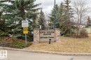 Stone and stucco monument sign with property name and address - 413 279 Suder Greens Drive, Edmonton, AB  - Outdoor With View 