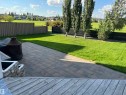 Expansive backyard featuring a paver patio, a manicured lawn, and mature trees lining the property boundary - 8477 Sloane Crescent, Edmonton, AB  - Outdoor 