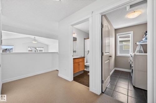 Upper-level landing with carpeted flooring - 8477 Sloane Crescent, Edmonton, AB - Indoor Photo Showing Other Room